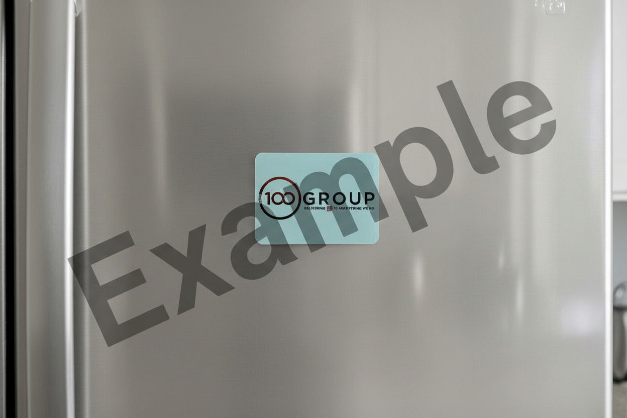 A magnet on a fridge that has "100 Group" sublimated on it.