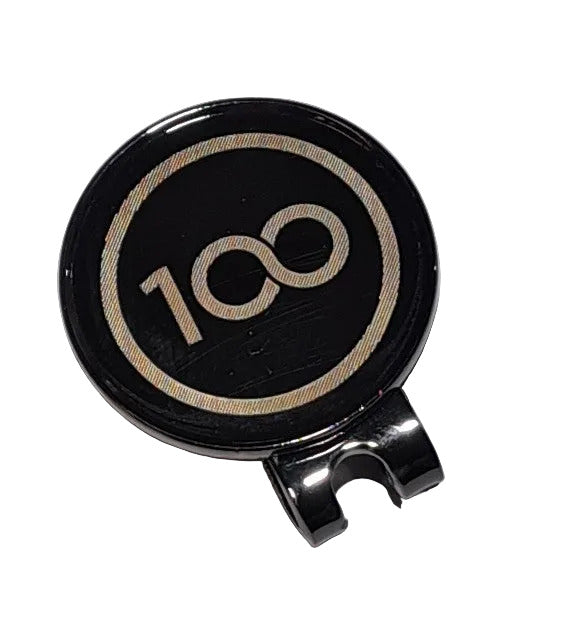 Black and silver round object with '100' engraving on a light gray background