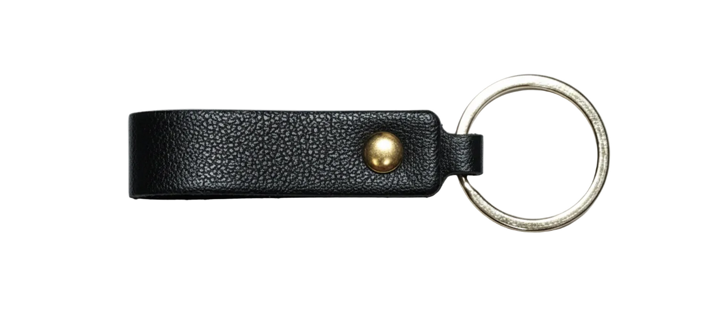 Black leather keychain with a gold accent pictured on a white background