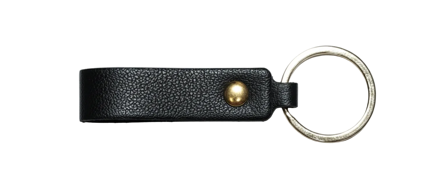 Black leather keychain with a gold accent pictured on a white background