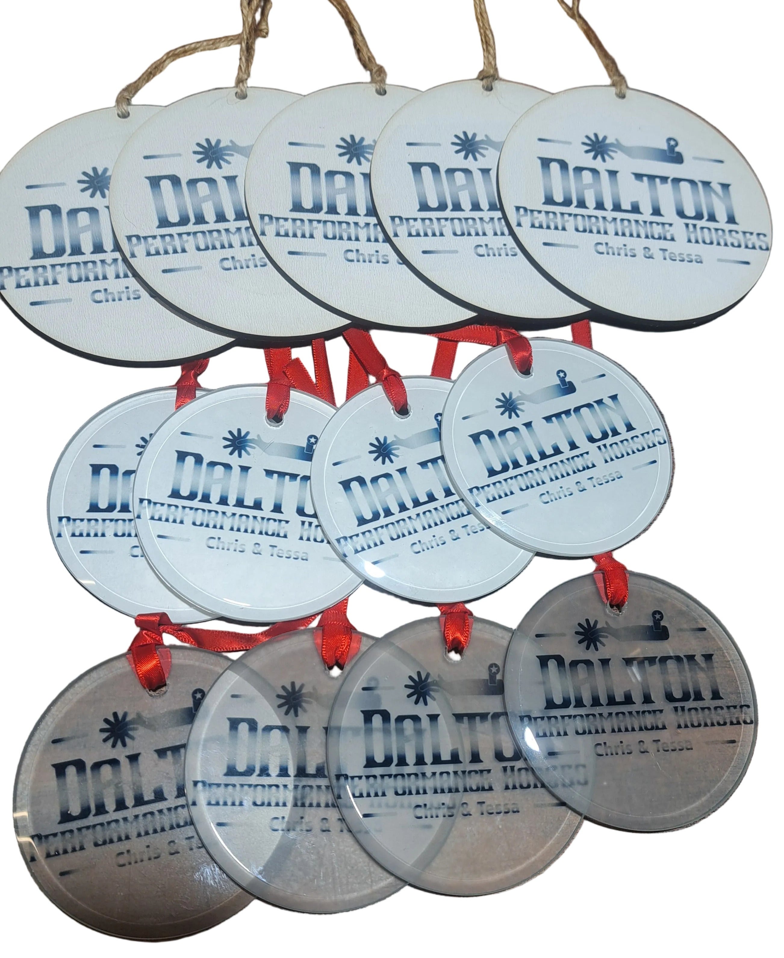 Various mdf and acrylic round ornaments with company logo's printed on them