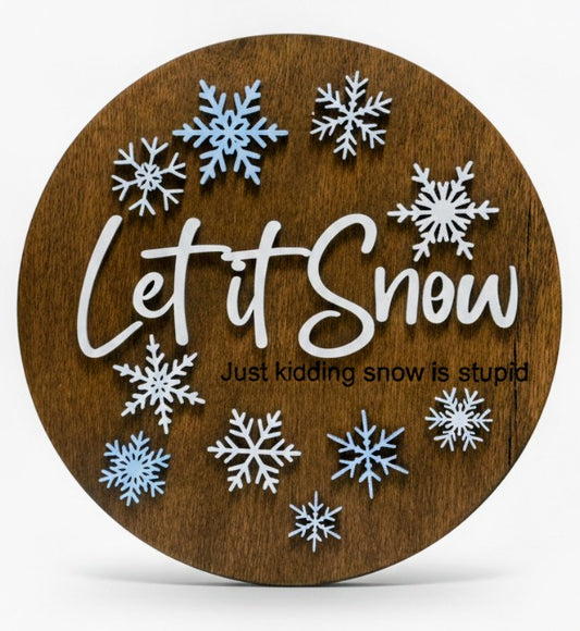 Thin wooden sign with 'Let it Snow'  (just kidding snow is stupid) text and snowflakes. Picture is on a white background